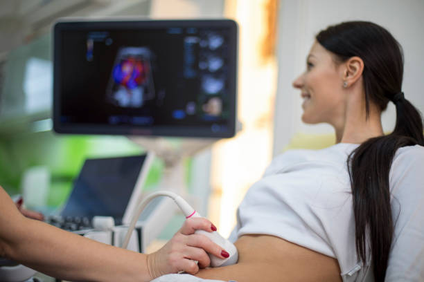istock Young woman having 4D ultrasound scan. 1259141392