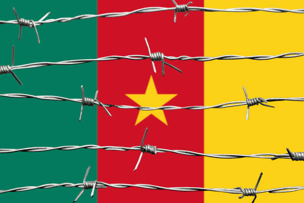 Hand with thumb down gesture in colored cameroon national flag as symbol of negative political, cultural, social management of country