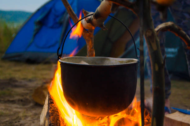 istock camping cauldron. cauldron at the stake. rest by the river 1259149973