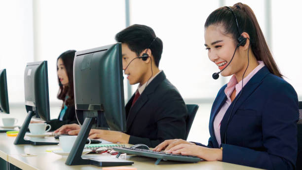 istock Business people wearing headset working in office 1259150858
