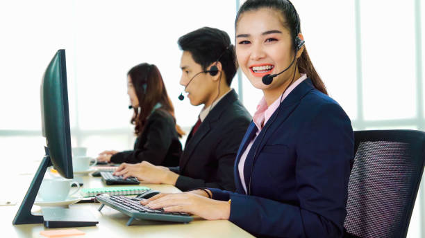 istock Business people wearing headset working in office 1259150910