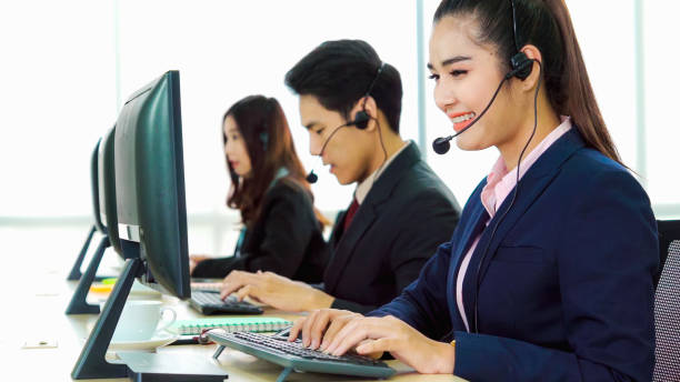 istock Business people wearing headset working in office 1259150924