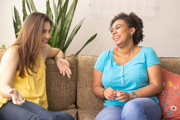 istock Two friends. Girls sitting on a sofa and talking. 1259151240