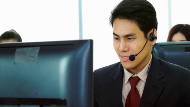 istock Business people wearing headset working in office 1259151303