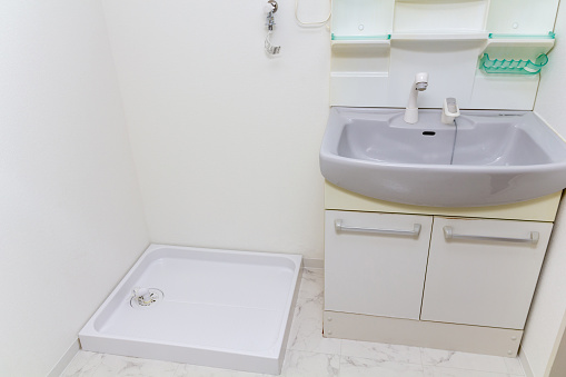 Inside of apartment house in Japan. Waterproof pan for washing machine, after renovation.