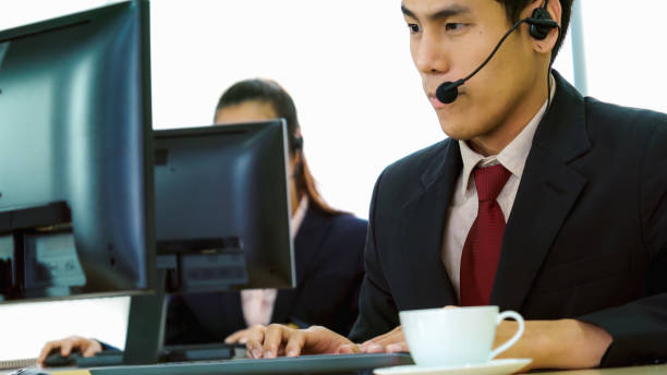 istock Business people wearing headset working in office 1259151436