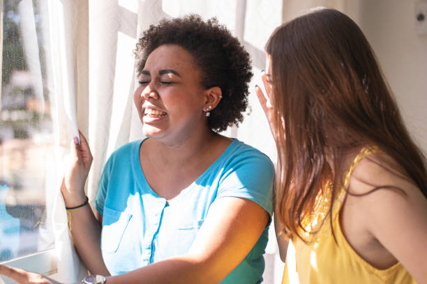 istock Two friends. Girls sitting on a sofa and talking. 1259151520