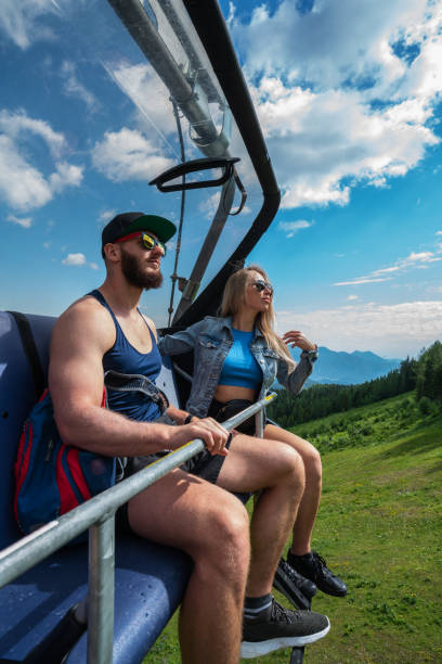 istock Young woman and a man on a ski lift in Hinterstoder ski and hiking resort 1259151768
