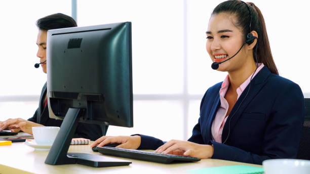 istock Business people wearing headset working in office 1259151854
