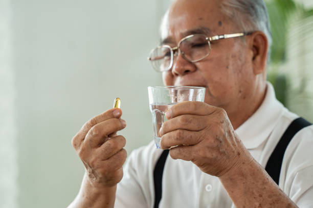 istock Elderly Asian man taking pill 1259152627