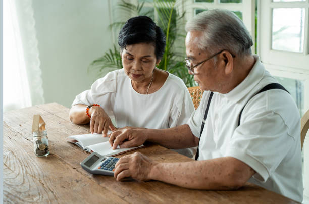 istock Asian senior couple stressed and serious counting with calculator and having money problem 1259152645