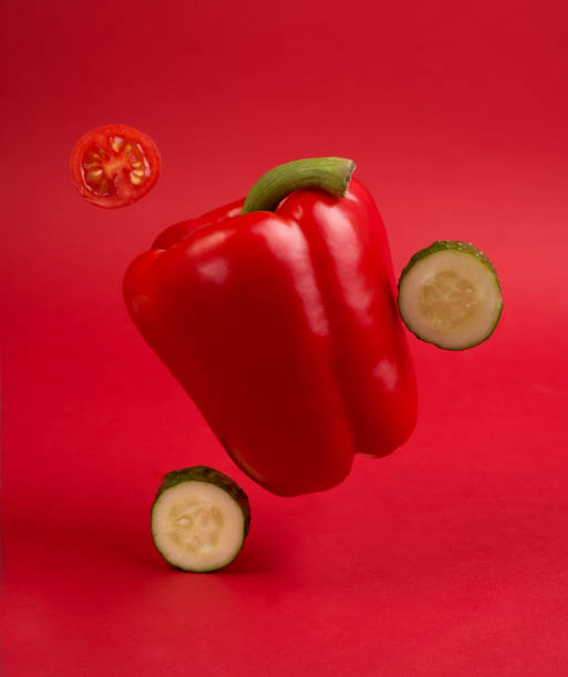 istock Creative concept with fresh sweet red pepper flying against red background. 1259152657