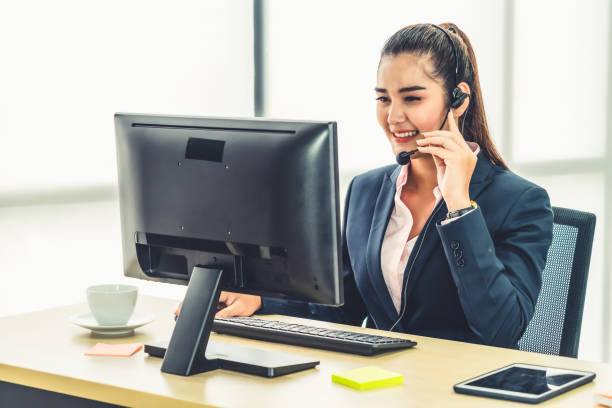 istock Business people wearing headset working in office 1259155193