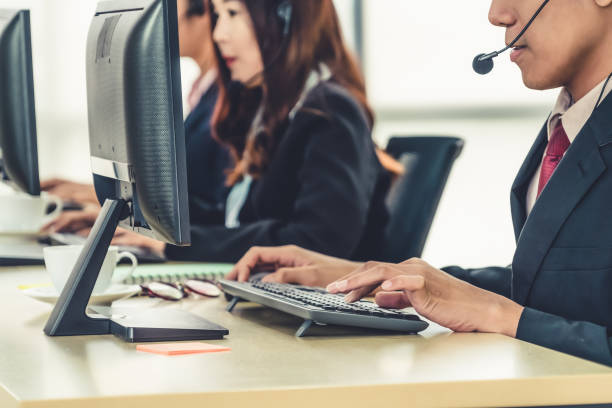 istock Business people wearing headset working in office 1259159370
