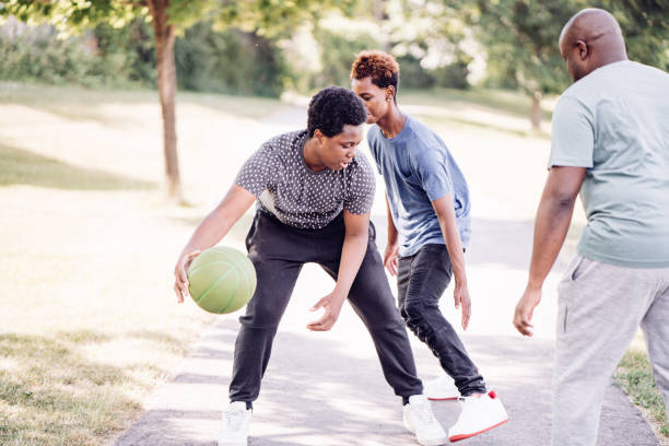 istock Teens playing basketball with dad outdoor 1259160179