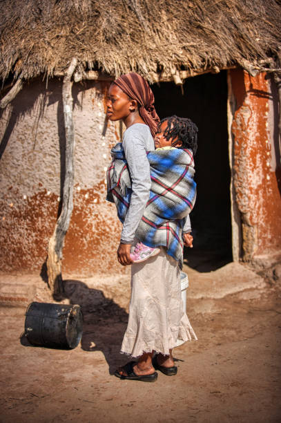istock african woman carry her child 1259161782