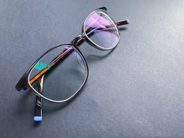 istock plastic frame on a dark background.  glasses with anti-reflective coating.  vision correction. 1259196539