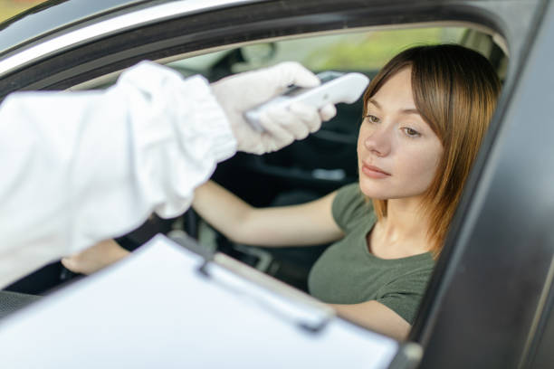 istock Checking body temperature for Covid 19 in a public place 1259199650