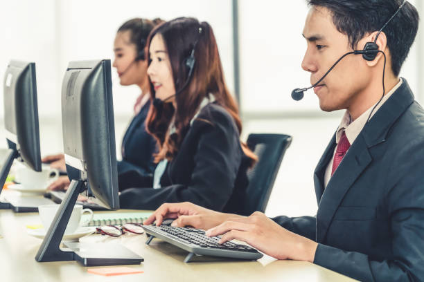 istock Business people wearing headset working in office 1259202770