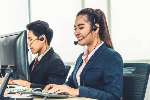 istock Business people wearing headset working in office 1259208001