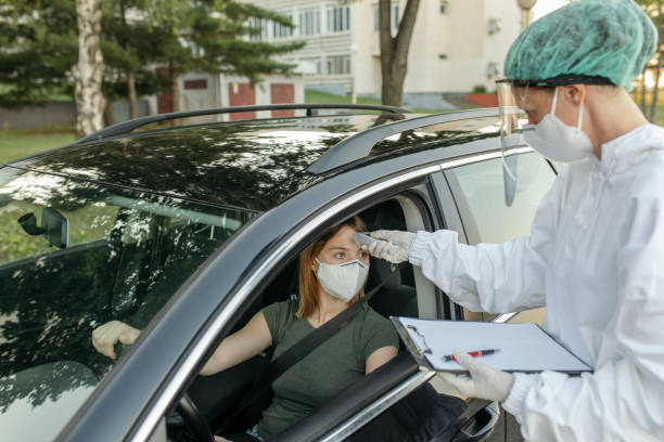 istock Checking body temperature for Covid 19 in a public place 1259211742