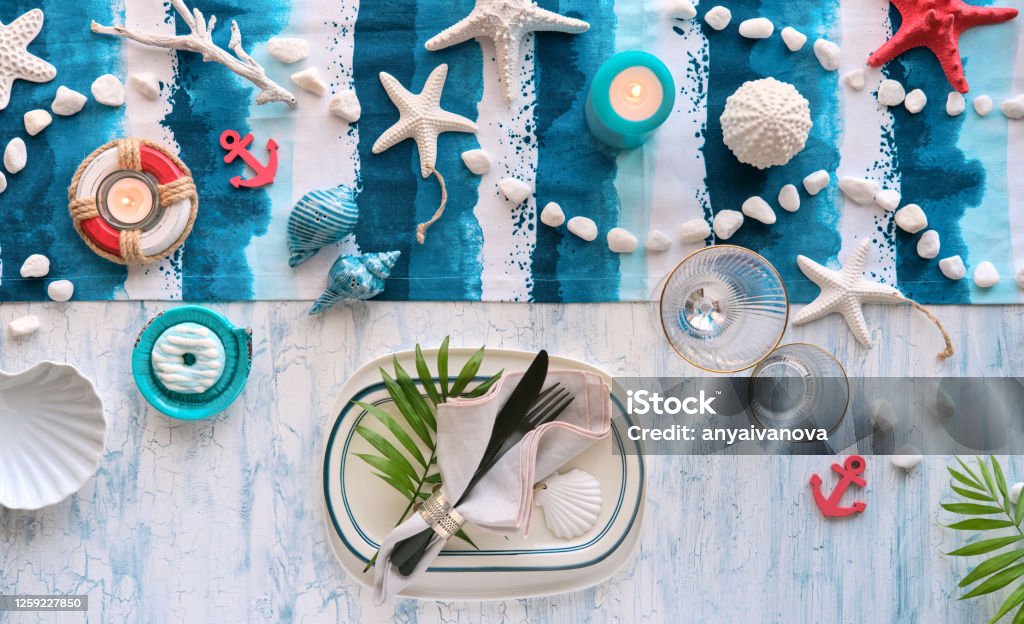 Contemporary Summer Table Setting With Nautical Sea Decorations On