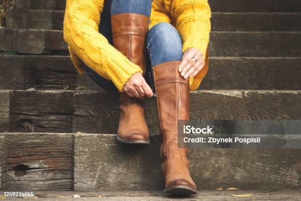 Woman Fasten Zipper On Her Leather Boot Stock Photo - Download Image Now - Boot, Riding Boot, One Woman Only