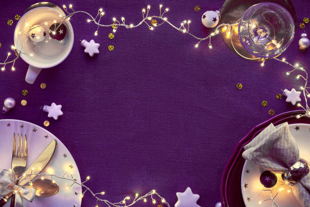 istock Christmas table setup with white and gold. Flat lay, copy-space on dark purple linen tablecloth. 1259242982