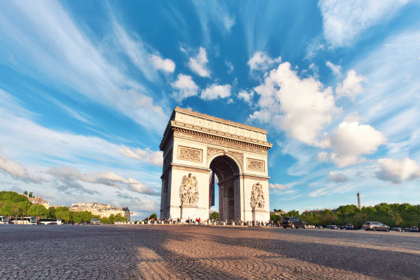istock Arc de Triumph in Paris, France, on an empty square with feather clouds in blue sky above, panorama 1259264604