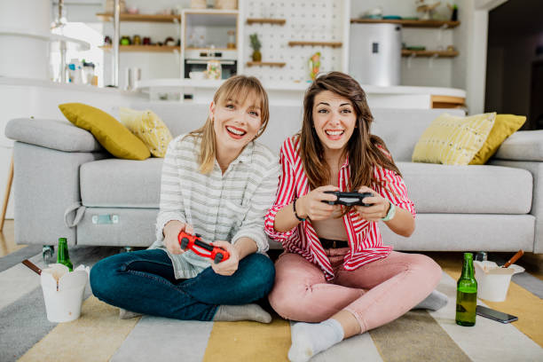 istock Female friends playing video games 1259275031