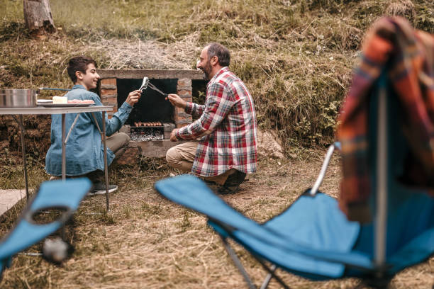 istock Father and son have fun while preparing the barbecue 1259277477