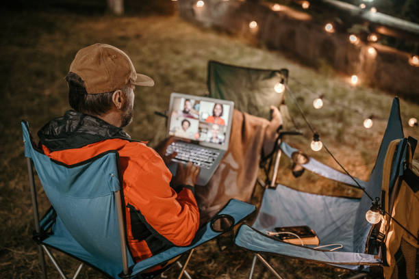 istock Video call with team members late night in nature 1259280737