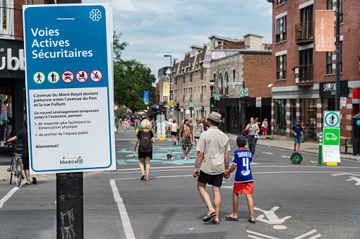 Montreal, CA - 26 July 2020: Voies actives securitaires (safe active transportation circuit) on Mont Royal Avenue are pedestrians areas to ease social distancing during Covid-19 pandemic
