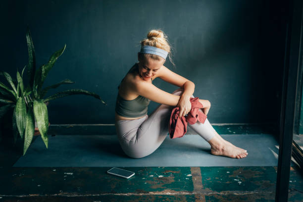 istock Happy Blonde Woman Using a Smartphone While Doing Yoga at Home 1259290851