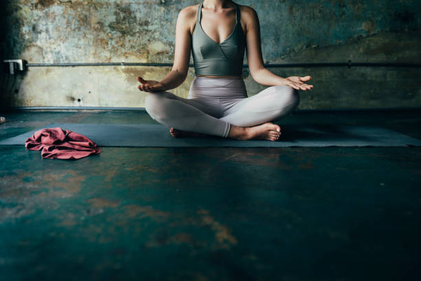 istock Anonymous Woman Meditating at Home, Staying Active during the Lockdown Concept 1259290863