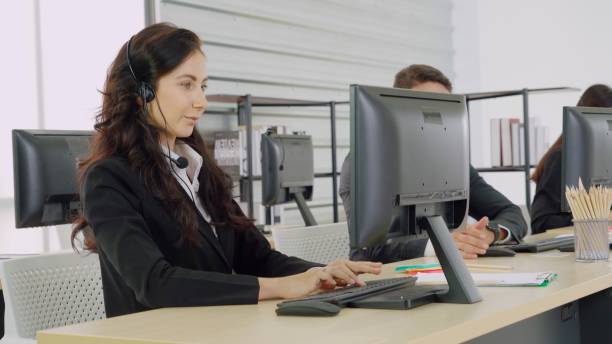 istock Business people wearing headset working in office 1259293528