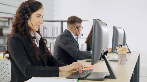 istock Business people wearing headset working in office 1259296215