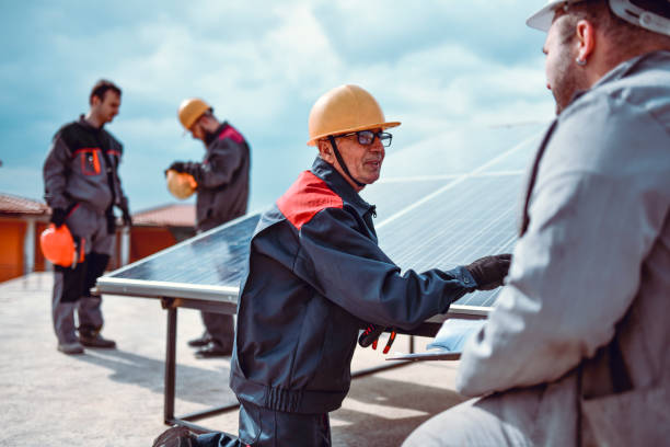istock Workers Engaged In Repairing Solar Panel On House Roof 1259296328