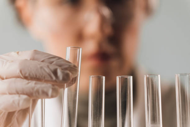 Lab technician working with test tubes, a close up.