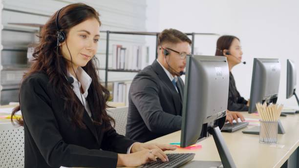 istock Business people wearing headset working in office 1259306039