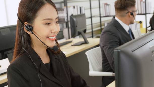 istock Business people wearing headset working in office 1259313237