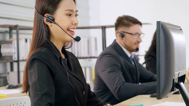 istock Business people wearing headset working in office 1259316904