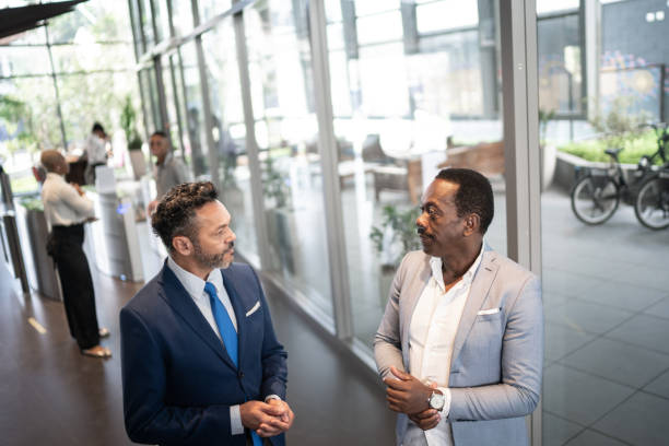istock Two businessmen having a conversation in office lobby 1259322123
