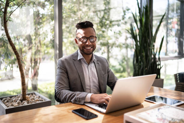 istock Portrait of a businessman working in an office, using laptop 1259343301