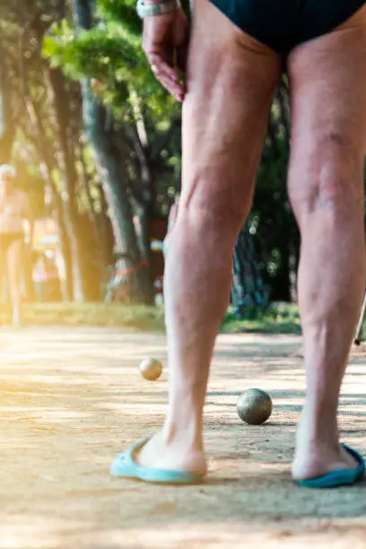 senior citizens playing boules on the beach