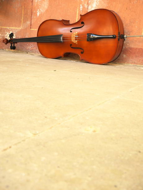 istock Cello on the white stone floor. Copy space 1259370216