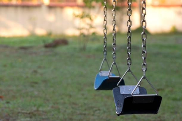 istock Empty swingseat at the playground. Closeup, copy space. 1259387125
