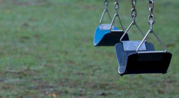 istock Empty swingseat at the playground. Closeup, copy space. 1259387157