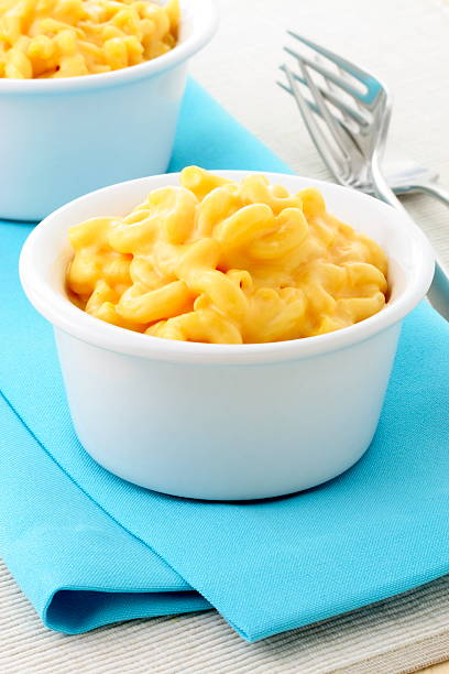Two white bowls full of macaroni and cheese stock photo