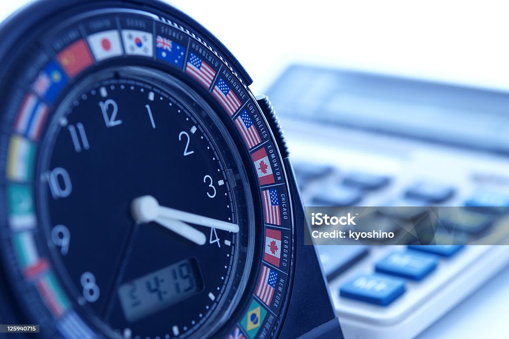 Blue tinted image of world time clock with calculator Blue tinted image of world time clock with calculator. Australia Stock Photo